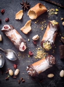 Sweet homemade cannoli stuffed with ricotta cheese cream from above,selective focus